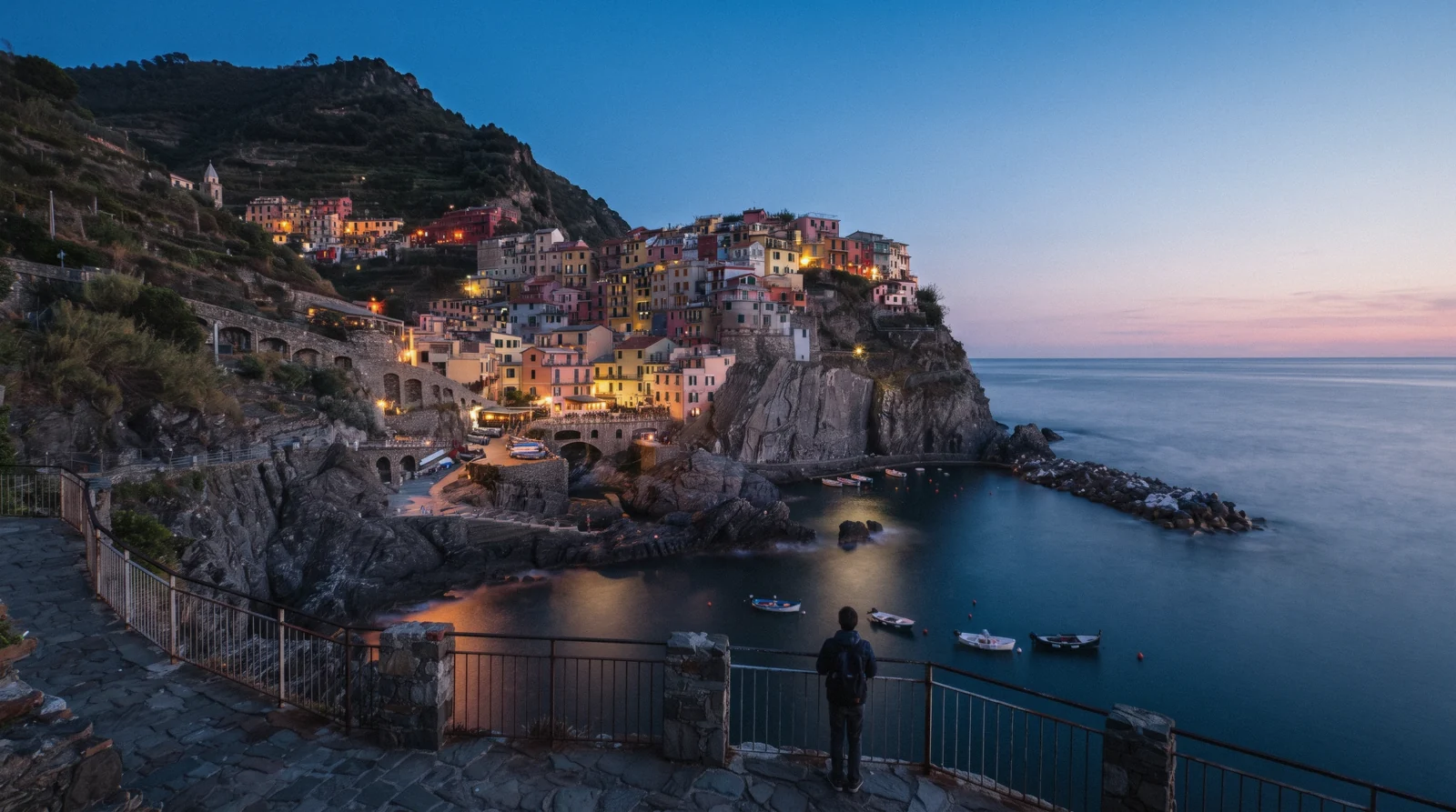 Manarola, Cinque Terre, the harbour and the coloured houses on the cliff at sunset