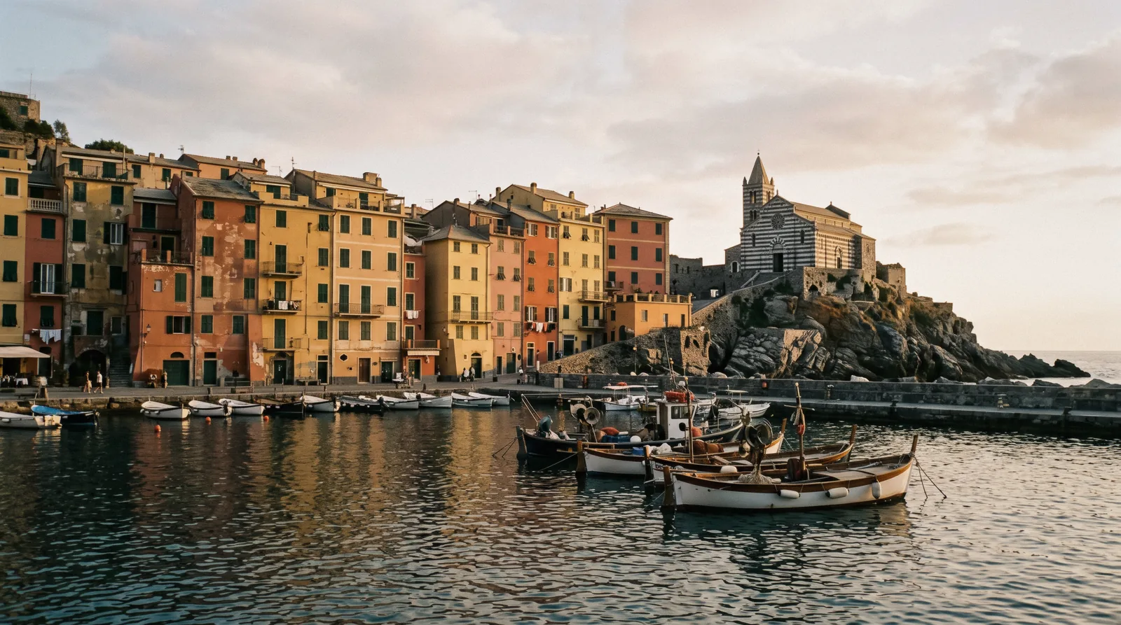 Portovenere harbour and the striped Church of San Pietro on the promontory, Liguria, Italy, near the Cinque Terre