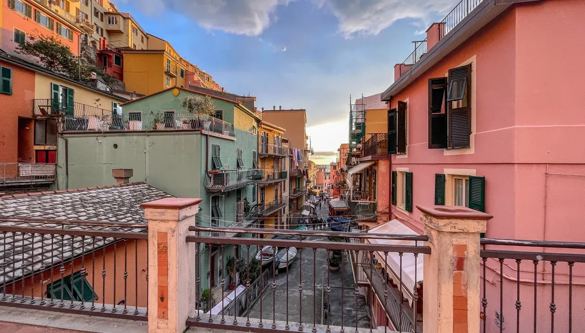 A colourful narrow street in Manarola, Cinque Terre, between tall pastel houses