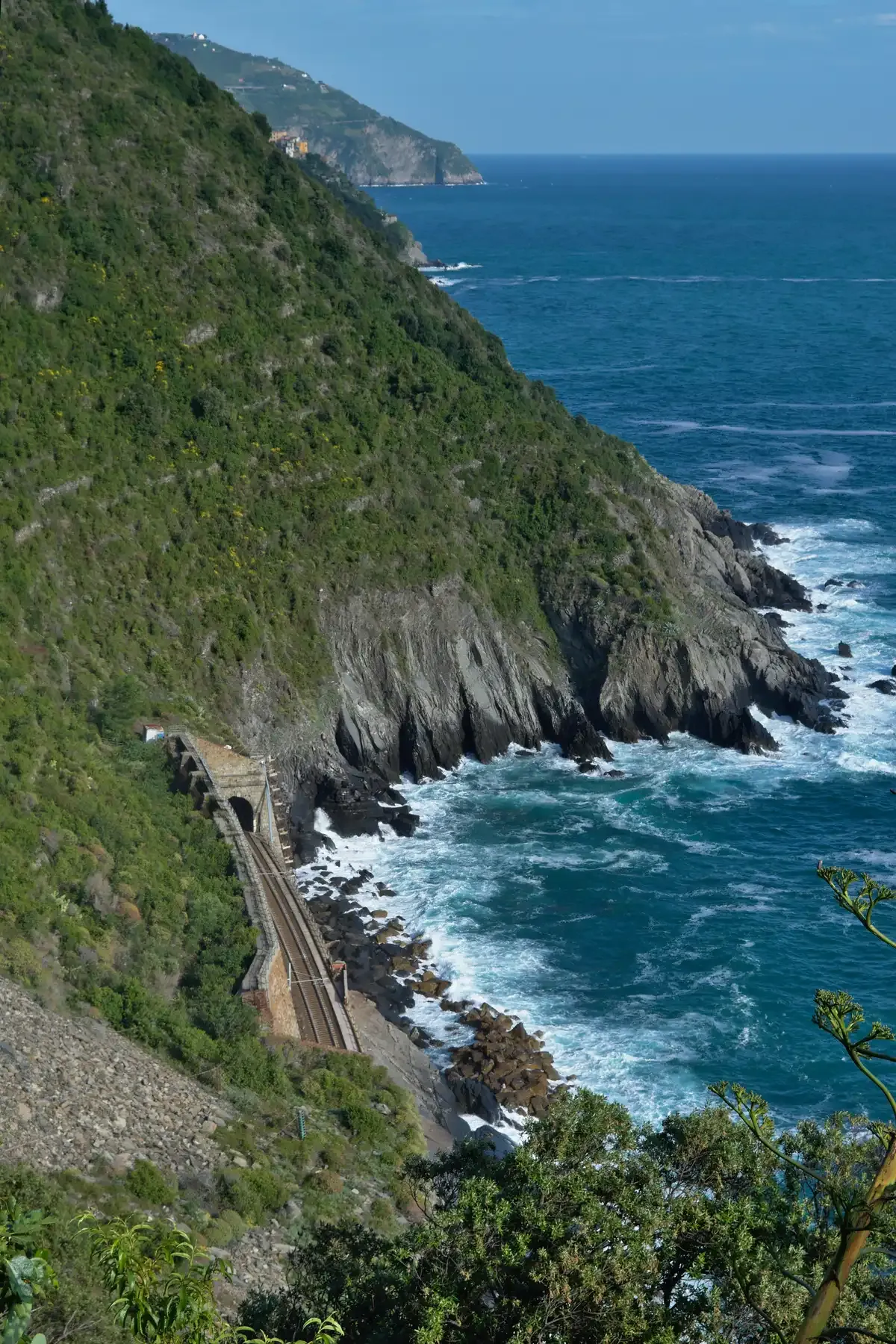 Coastal cliffs and railway bridge along the Sentiero Azzurro Blue Trail near Vernazza, Cinque Terre, Italy